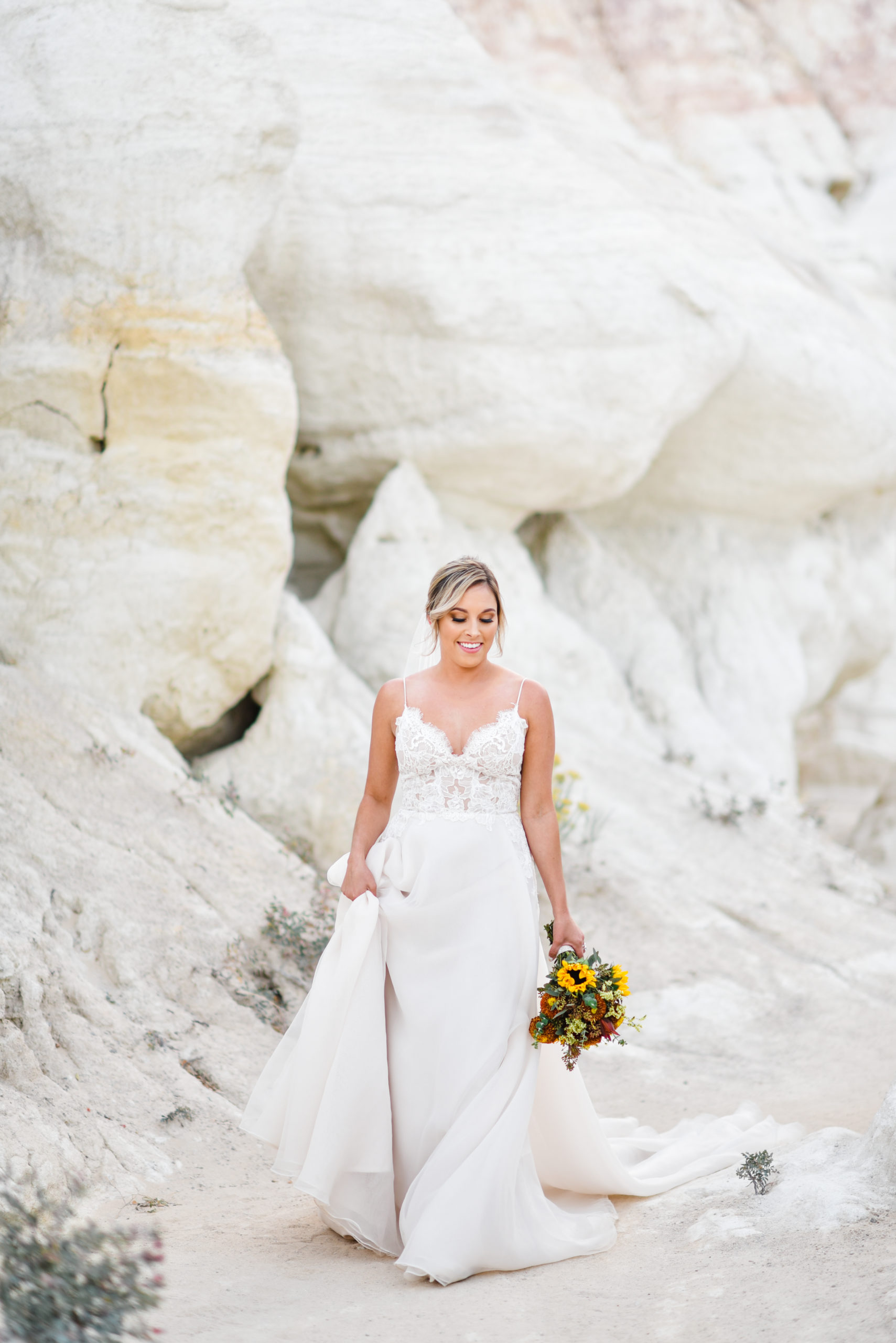 Bride walking in the Paint Mines in white dress during Colorado Springs Elopement