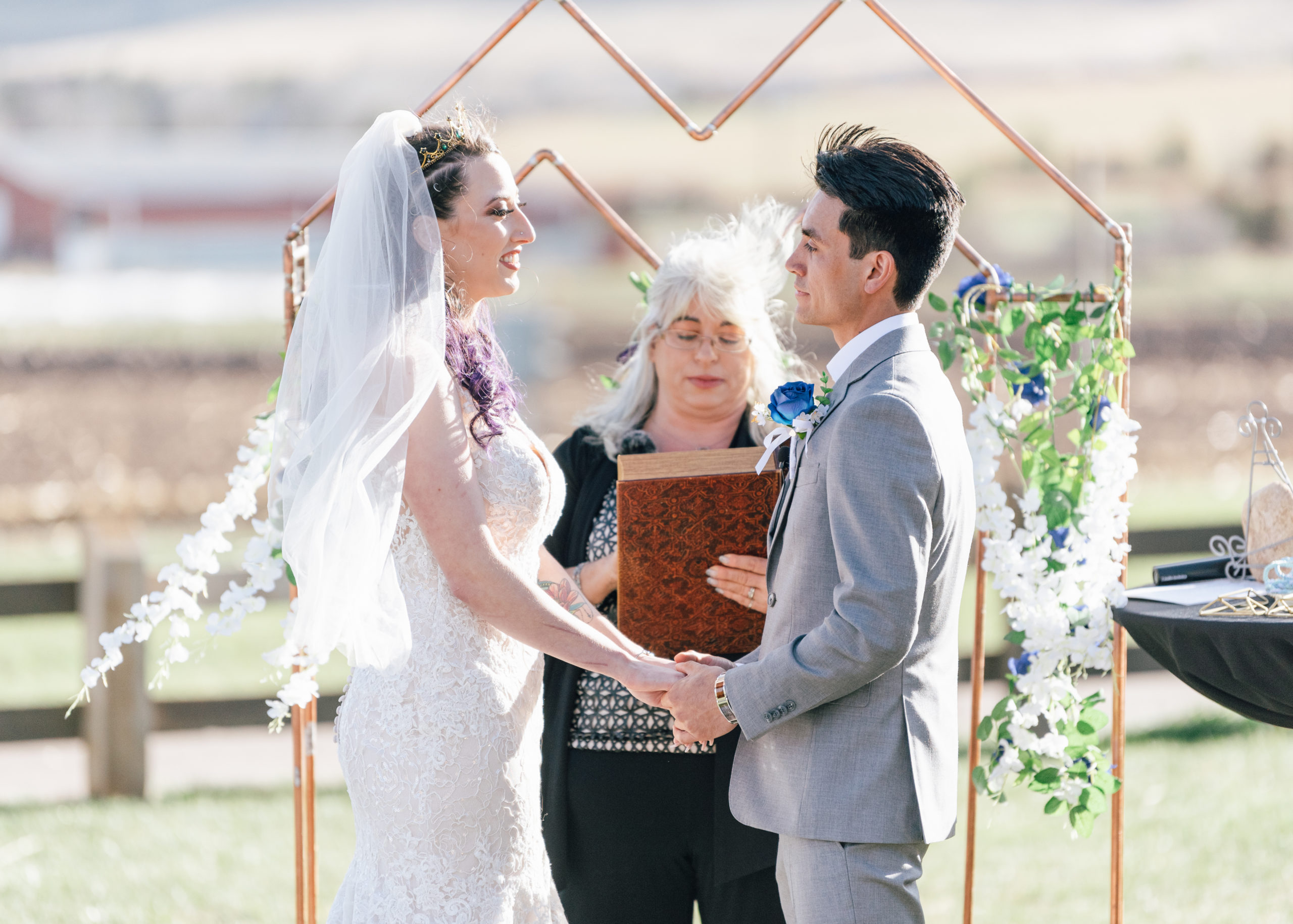 bride and groom smiling during denver botanic gardens wedding ceremony