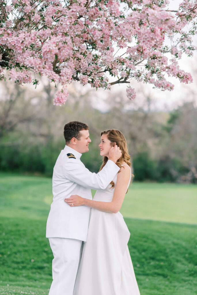 Bride and Groom share an intimate moment under a pink flowering tree at their Washington DC Wedding Venue