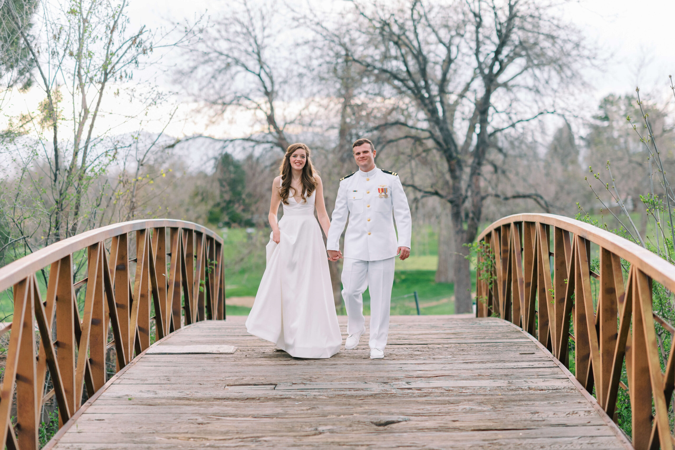 Naval Officer groom and his new bride walk along a bridge at a Washington DC Wedding Venue