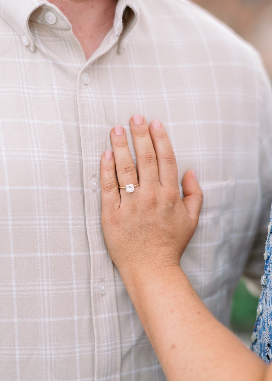 A newly engaged woman rests her hand on the chest of her fiance after their Washington DC Wedding Proposal