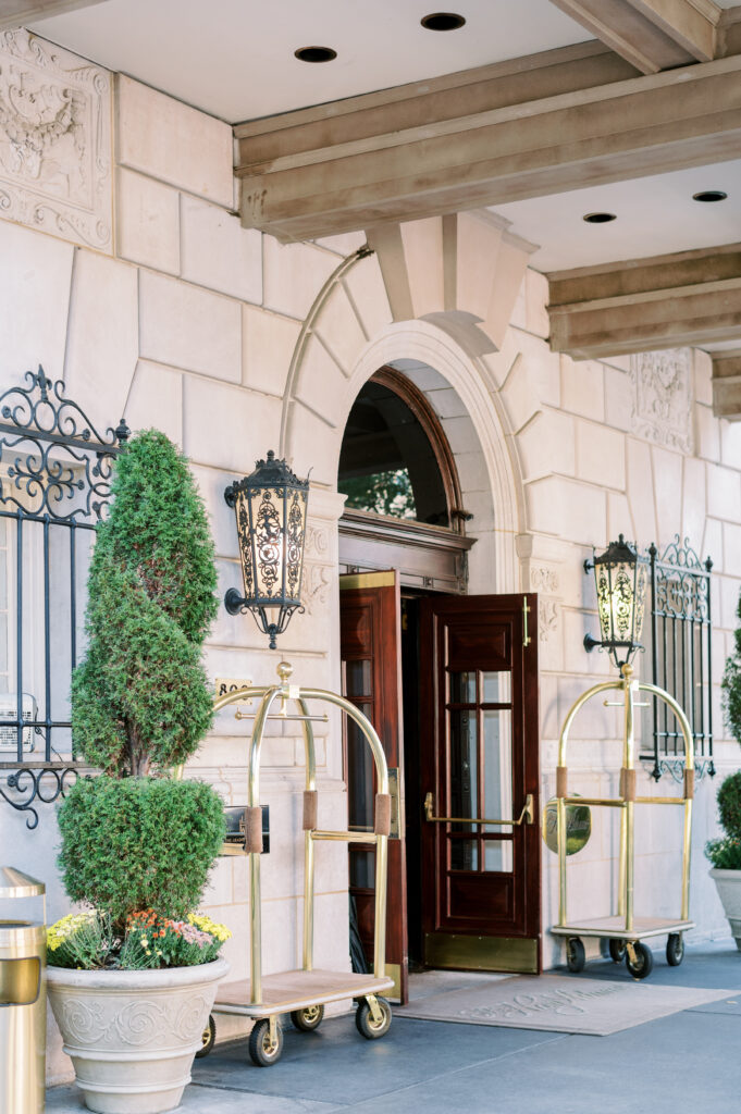 The entrance to the Hay Adams features heavy spinning wooden doors, plants, and more.