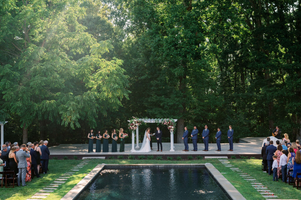 An outdoor wedding occurs amid the lush green of Dover Hall Estate in Virginia