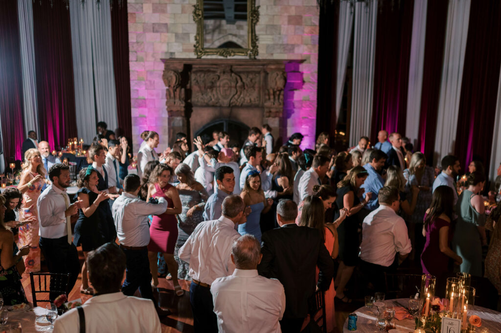 A large party dances during the reception portion of a wedding at Dover Hall Estate